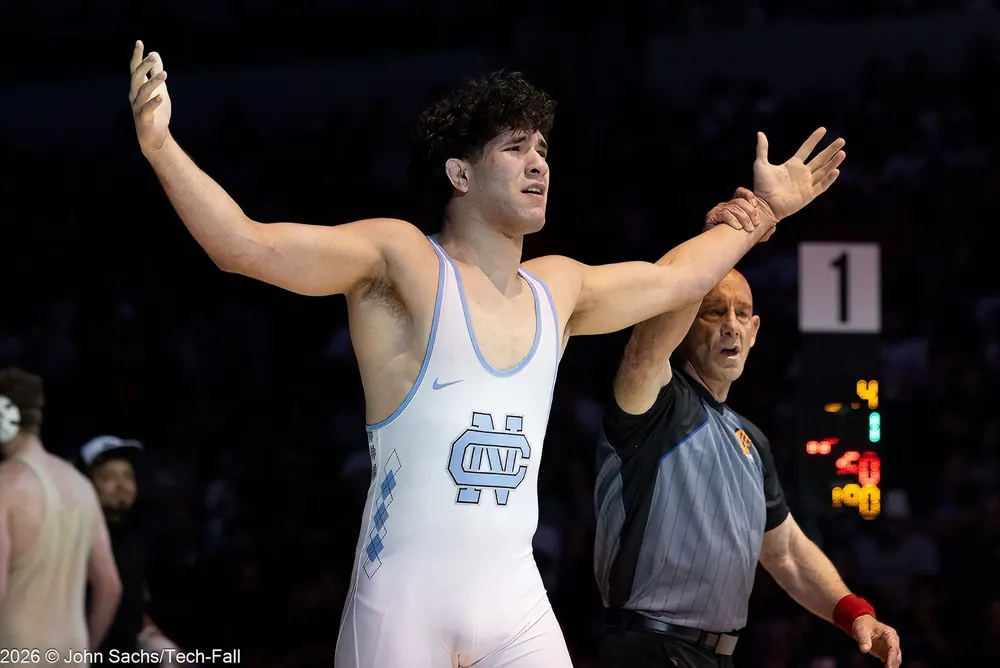 An official raises a wrestler's hand on mat number 1.
